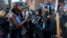 Demonstrators talk to police in riot gear as they protest the death of George Floyd, Saturday, May 3