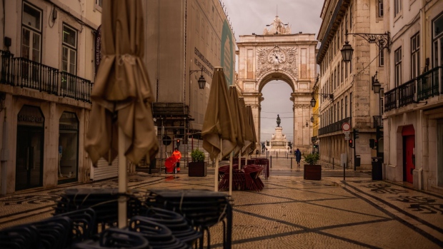 Empty chairs and collapsed sun parasols stand stacked along Rua Augusta outside closed restaurants and cafes in Lisbon, Portugal on Thursday, May 14, 2020. The European Union’s executive arm pushed for a continent-wide revival of tourism with a series of policy recommendations for EU countries as they loosen lockdowns triggered by the coronavirus pandemic. Photographer: Jose Sarmento Matos/Bloomberg