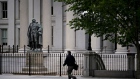 A pedestrian walks near the U.S. Treasury building in Washington. Photographer: Andrew Harrer/Bloomberg