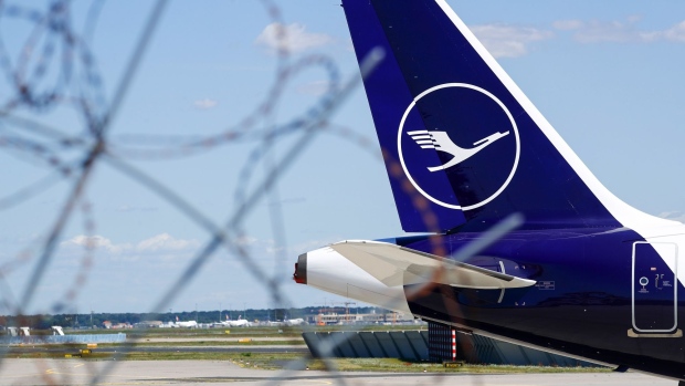 A Deutsche Lufthansa AG logo sits on the tail fin of a grounded passenger jet, manufactured by Airbus SE, at Frankfurt Airport, operated by Fraport AG, in Frankfurt, Germany, on Thursday, May 28, 2020. The German government bristled at the European Commission’s antitrust demands on its 9 billion-euro ($9.9 billion) bailout of Deutsche Lufthansa AG, in a sign of rising tensions over the stalled aid package. Photographer: Alex Kraus/Bloomberg