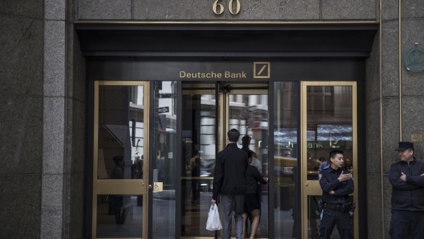 People enter Deutsche Bank AG headquarters on Wall Street in New York, U.S., on Thursday, April, 26, 2018. Deutsche Bank AG is planning to cut more than 10 percent of U.S. jobs as it withdraws from businesses where it can't compete, a person briefed on the matter said. Photographer: Victor J. Blue/Bloomberg