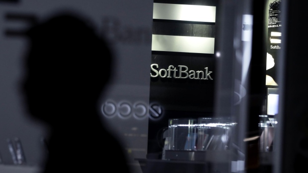 The SoftBank Corp. logo is displayed inside a store in Tokyo, Japan, on Tuesday, April 14, 2020. SoftBank Group forecast a record 1.35 trillion yen ($12.5 billion) operating loss for the fiscal year ended in March, a sign of how badly Masayoshi Son's bets on technology startups have been battered in recent months. Photographer: Kiyoshi Ota/Bloomberg