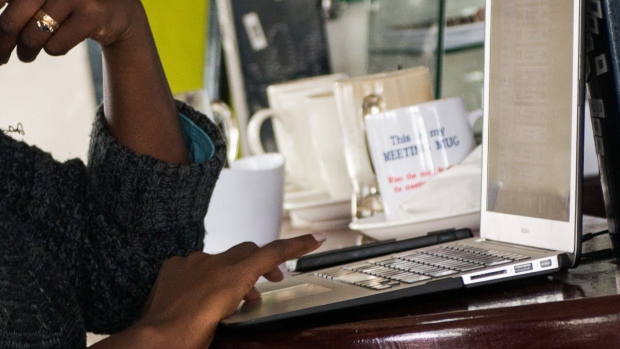 A visitor works on a laptop computer at the coffee bar inside the i-Hub technology innovation center in Nairobi, Kenya, on Thursday, July 23, 2015. Together, the entrepreneurs come up with concepts like Ushahidi, the open-source software that's used to share information and interactive maps to prevent conflicts and help aid agencies provide relief in disaster zones. Photographer: Bloomberg/Bloomberg