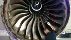 An employee inspects a Rolls-Royce Trent XWB engine in Berlin. Photographer: Adam Berry/Getty Images