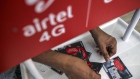 A vendor arranges Bharti Airtel Ltd. SIM card packets at a stall in Mumbai, India, on Sunday, Jan. 19, 2020. Telecom companies including Bharti and Vodafone Idea Ltd. have sought more time from India's top court to pay $13 billion in past dues as they plan to negotiate with the government, people with knowledge of the matter said. Photographer: Dhiraj Singh/Bloomberg