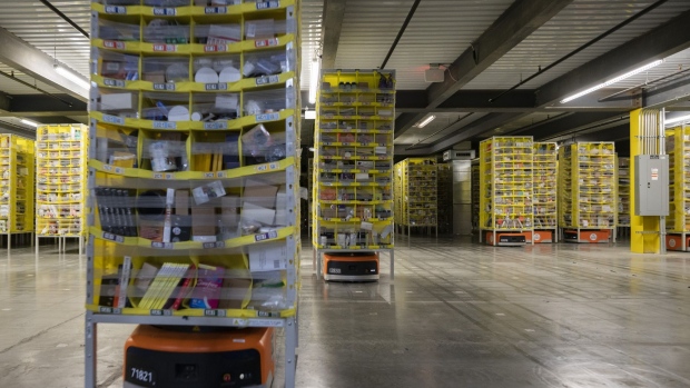 Kiva Systems Inc. robots move shelves at the Amazon.com Inc. fulfillment center in Baltimore, Maryland, U.S., on Tuesday, April 30, 2019. Amazon.com will spend $800 million in the current quarter to reduce delivery times for top customers to one day from two, trying to revive its main e-commerce franchise and ward off greater competition. Photographer: Melissa Lyttle/Bloomberg