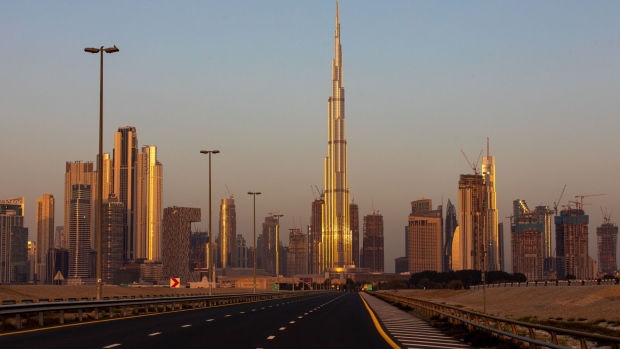 An empty highway leads towards the Burj Khalifa skyscraper, center, and other office buildings on the city skyline during the coronavirus lockdown in Dubai, United Arab Emirates, on Friday, April 24, 2020. An investment firm backed by a member of Abu Dhabi’s royal family agreed to buy a stake worth just over $1 billion in LuLu Group International, which runs one of the Middle East’s largest hypermarket chains, according to people familiar with the matter. Photographer: Christopher Pike/Bloomberg