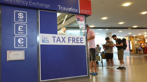 A traveler exchanges currency at a Travelex Holdings Ltd. bureau de change at Tegel airport, operated by Flughafen Berlin Brandenburg GmbH, in Berlin, Germany, on Monday, July 29, 2019. Deutsche Lufthansa AG is considering a shift to a corporate holding structure, seeking to streamline Europe's biggest airline group as it fights for market share. Photographer: Krisztian Bocsi/Bloomberg