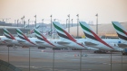 Passenger aircraft, operated by Emirates, stand beside the terminal building at Dubai International Airport in Dubai, United Arab Emirates, on Monday, May 18, 2020. Emirates Group is considering plans to cut about 30,000 jobs as the operator of the world’s largest long-haul carrier seeks to reduce costs after the coronavirus pandemic grounded air travel. Photographer: Christopher Pike/Bloomberg