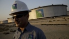 An employee visits the site of crude oil storage tanks at the Juaymah tank farm at Saudi Aramco's Ras Tanura oil refinery and oil terminal in Ras Tanura, Saudi Arabia, on Monday, Oct. 1, 2018. Saudi Aramco aims to become a global refiner and chemical maker, seeking to profit from parts of the oil industry where demand is growing the fastest while also underpinning the kingdoms economic diversification. Photographer: Bloomberg/Bloomberg