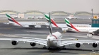 An Airbus SE A380-800 aircraft, operated by Emirates, taxis at Dubai International Airport in Dubai, United Arab Emirates, on Monday, March 23, 2020. Dubai-based Emirates, the largest long-haul airline, and neighbor Etihad of Abu Dhabi will stop flying passengers for two weeks from Wednesday because of local restrictions. Photographer: Christopher Pike/Bloomberg