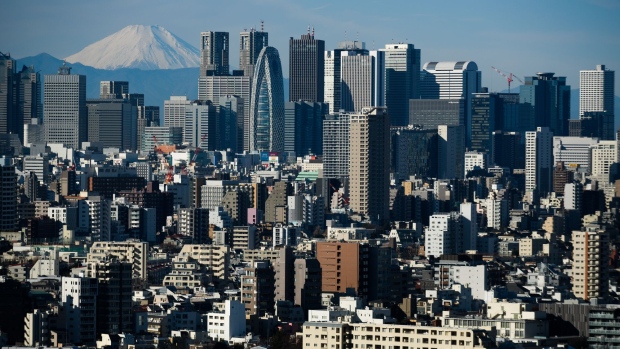 Mount Fuji stands beyond buildings in Tokyo, Japan, on Friday, Jan. 11, 2019. Japan’s key inflation gauge slowed in the first back-to-back decline since April, highlighting the difficulty of the Bank of Japan’s price goal ahead of its policy meeting next week. Photographer: Akio Kon/Bloomberg