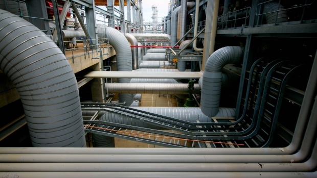 Gas pipes run through a plant at the Queensland Curtis Liquefied Natural Gas (QCLNG) project site, operated by QGC Pty, a unit of Royal Dutch Shell Plc, in Gladstone, Australia, on Wednesday, June 15, 2016. Gas from more than 2,500 wells travels hundreds of miles by pipeline to the project, where it's chilled and pumped into 10-story-high tanks before being loaded onto massive ships. Photographer: Patrick Hamilton /Bloomberg