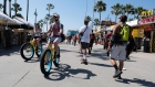 Cyclists ride along the Venice Beach boardwalk on May 25.