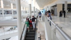 Shoppers ride an escalator at a mall in Bloomington, Minnesota in June 10. Photographer: Emilie Richardson/Bloomberg
