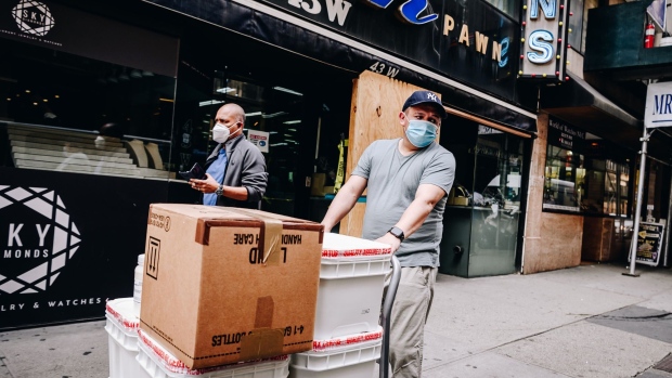 A worker wearing a protective mask pushes a cart in the Diamond District of New York, U.S., on Wednesday, June 10, 2020. New York streets got a little more congested this week as the city entered Phase 1 of its re-opening from the coronavirus-imposed lockdown. Photographer: Nina Westervelt/Bloomberg