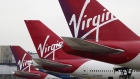 Logos sit on the tailfins of Virgin Atlantic aircraft at Gatwick airport in Crawley, U.K., on Thursday, Jan. 10, 2013.