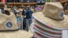 Shoppers wearing protective masks browse clothing at a store in Long Beach, New York, U.S., on Thursday, June 11 2020. Long Island officially entered Phase 2 of its reopening from the coronavirus pandemic Wednesday, with outdoor dining and some in-store retail stores are back in business for the first time in weeks. Photographer: Johnny Milano/Bloomberg