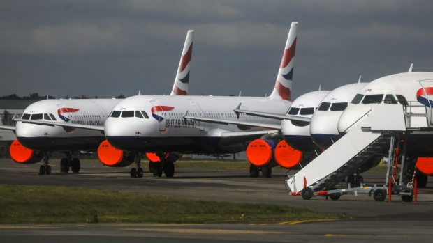 Passenger aircraft, operated by British Airways, a unit of International Consolidated Airlines Group SA (IAG), sit grounded with their engines covered at Bournemouth Airport in Bournemouth, U.K., on Tuesday, March 31, 2020. European airlines will take the biggest hit to demand from the coronavirus, with passenger traffic set to fall 46% this year, according to economists at the International Air Transport Association. Photographer: Simon Dawson/Bloomberg