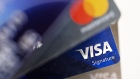 Visa Inc. and Mastercard Inc. credit cards are arranged for a photograph in Tiskilwa, Illinois, U.S., on Tuesday, Sept. 18, 2018. 