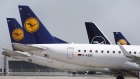 The Deutsche Lufthansa AG logo sits on the tail fins of passenger aircraft on the tarmac at Munich airport in Munich, Germany, on Wednesday, June 3, 2020. Deutsche Lufthansa AG signaled the start of a company-wide revamp spanning job cuts to asset disposals to help repay its 9 billion-euro ($10 billion) bailout from the German government. Photographer: Michaela Handrek-Rehle/Bloomberg
