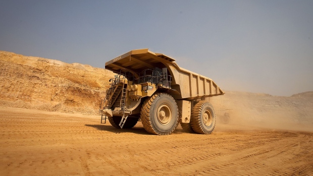 A mining truck leaves for the processing plant after collecting newly-excavated ore from the open pit in Kolwezi, Katanga province, Democratic Republic of Congo. Photographer: Simon Dawson/Bloomberg