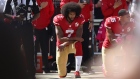 Colin Kaepernick, center, kneels for the National Anthem before a game in Santa Clara, California in 2016.
