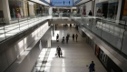 Shoppers walk through the Rideau Centre in Ottawa, Canada, on June 12. Photographer: David Kawai/Bloomberg