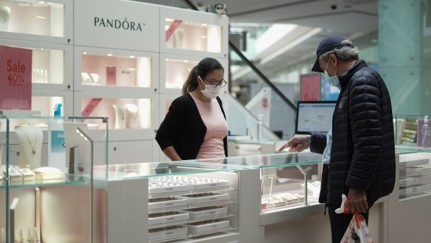 A shopper wearing a protective mask browses jewelry at the Unicentro mall in Bogota, Colombia, on Tuesday, June 16, 2020. Colombian retail sales slumped 42.9% in April from a year earlier, in a sign that the economic devastation caused by the coronavirus pandemic is even worse than expected.