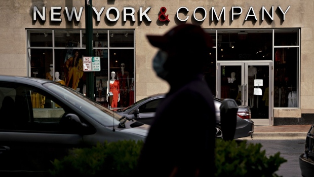 A pedestrian wearing a protective mask walks near a temporarily closed New York & Co. store in Silver Spring, Maryland, U.S., on Friday, June 5, 2020. RTW Retailwinds Inc., the owner of women's apparel seller New York & Co., could be the next struggling retailer to file for bankruptcy protection as the Covid-19 pandemic batters mall-based stores.