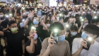 Demonstrators wearing protective masks shine lights from their smartphones during a protest in the Causeway Bay district of Hong Kong, China, on Friday, June 12, 2020. One of China’s top agencies responsible for Hong Kong urged the city’s education departments to “cut off” the “black hands” influencing its school system, in response to students’ plans for a weekend referendum vote to determine whether to strike against new national security legislation. Photographer: Justin Chin/Bloomberg