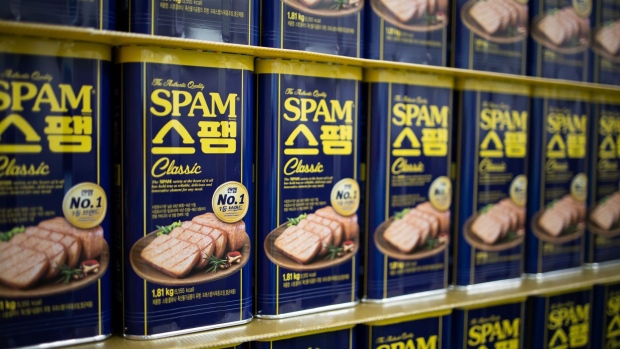 CJ CheilJedang employees sort cuts of pork on the production line for Spam ham at the company's factory in Jincheon, South Korea in 2019.