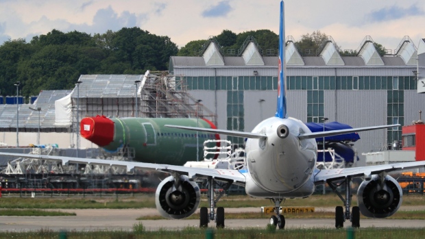 An Airbus A321 NEO passenger aircraft, operated by China Southern Airlines Co., taxis near a fuselage section outside the Airbus SE factory in Hamburg, Germany, on Wednesday, May 13, 2020. Airbus secured just nine net orders in April and delivered 14 jetliners after airlines desperate for cash put off accepting new planes and clamped down on spending to deal with a crisis that could last several years. Photographer: Krisztian Bocsi/Bloomberg