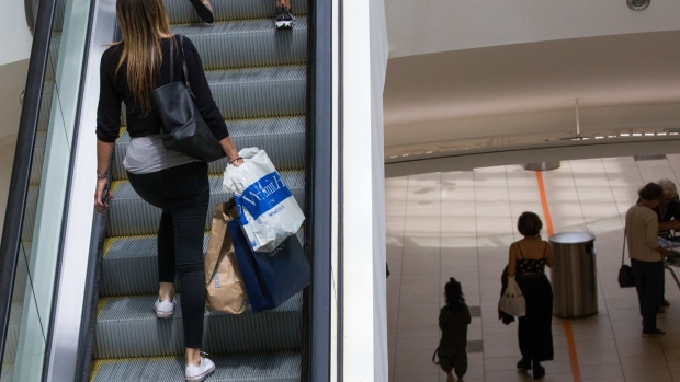 A shopper ascends an escalator at the Lakeside shopping centre, operated by Intu Properties Plc, in Thurrock, U.K., on Friday, June 19, 2020. U.K. retail sales started to recover last month from their precipitous drop during the coronavirus lockdown. Photographer: Chris Ratcliffe/Bloomberg