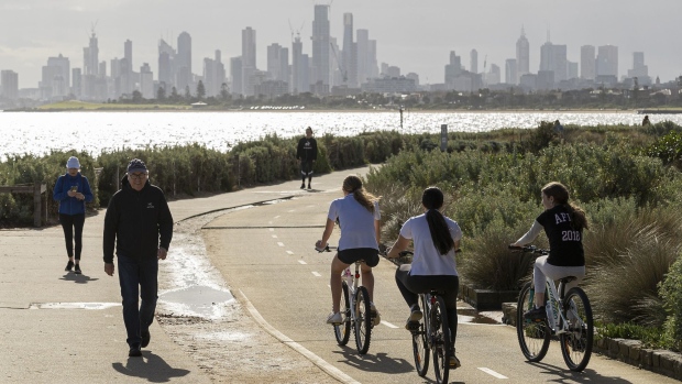 MELBOURNE, AUSTRALIA - MAY 13: People walk and ride along the beach at Brighton on May 13, 2020 in Melbourne, Australia. COVID-19 restrictions have eased slightly for Victorians in response to Australia's declining coronavirus (COVID-19) infection rate. From today, people in Victoria will be allowed to visit friends and family. A maximum gathering of up to ten outdoors is allowed, or up to five visitors inside a home. Golfing, hiking and fishing is also now permitted. (Photo by Daniel Pockett/Getty Images)