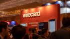 People gather around the Wirecard AG booth during the Money20/20 Asia Conference in Singapore, on Tuesday, March 19, 2019.