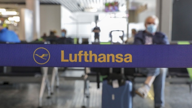The Deutsche Lufthansa AG logo sits on a departure hall cordon as the airline and airport operator Fraport AG showcase new coronavirus safety measures at Frankfurt Airport in Frankfurt, Germany, on Wednesday, June 17, 2020. Deutsche Lufthansa said a low turnout at its extraordinary general meeting next week is placing its 9 billion-euro ($10 billion) German bailout at risk of falling apart. Photographer: Alex Kraus/Bloomberg