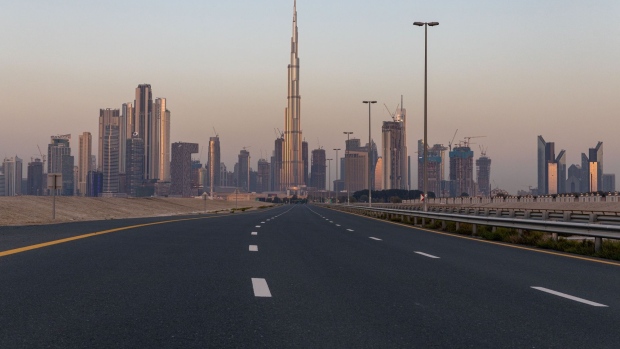 An empty highway leads towards the Burj Khalifa skyscraper, center, and other office buildings on the city skyline during the coronavirus lockdown in Dubai, United Arab Emirates, on Friday, April 24.