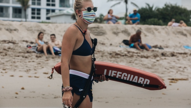 A lifeguard wearing a protective mask stands guard the current at the beach in Delray Beach, Florida on May 23, 2020