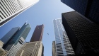 A bird flies between office towers in the financial district of Toronto, Ontario, Canada, on Friday, May 22, 2020. 