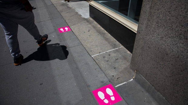 Social distancing markers are displayed in front of a T-Mobile US Inc. store in New York, U.S., on Wednesday, June 17, 2020. U.S. stocks fluctuated as the recent rally begins to show signs of losing momentum amid a worrying increase in coronavirus cases. Photographer: Michael Nagle/Bloomberg