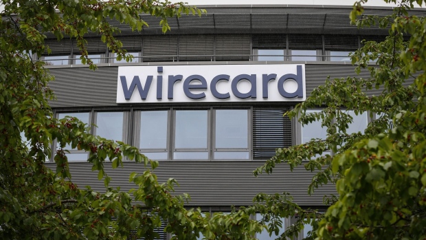 A sign hangs outside the Wirecard AG headquarters in the Aschheim district of Munich, Germany, on Friday, June 19, 2020. Wirecard shares continued their free-fall after the two Asian banks that were supposed to be holding 1.9 billion euros ($2.1 billion) of missing cash denied any business relationship with the German payments company. Photographer: Michaela Handrek-Rehle/Bloomberg