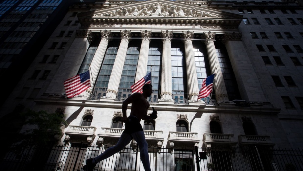 A jogger passes in front of the New York Stock Exchange (NYSE) in New York, U.S., on Wednesday, June 17, 2020. U.S. stocks fluctuated as the recent rally begins to show signs of losing momentum amid a worrying increase in coronavirus cases.