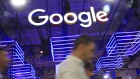 The Google Inc. logo hangs illuminated over the company's exhibition stand at the Dmexco digital marketing conference in Cologne, Germany. Photographer: Krisztian Bocsi/Bloomberg