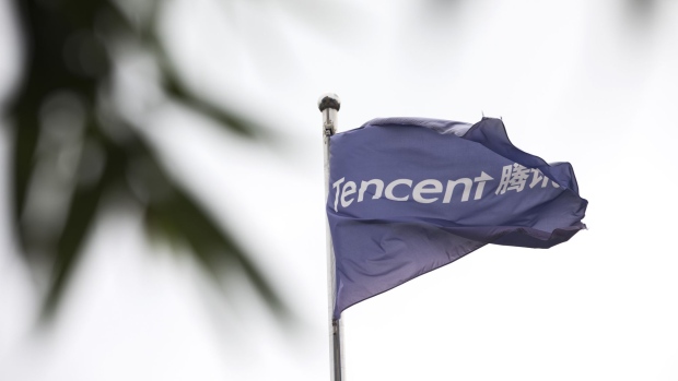 A flag bearing the Tencent Holdings Ltd. logo is displayed outside the company's offices in Beijing, China, on Tuesday, Aug. 14, 2018. Tencent, the Chinese internet giant best known for its popular games and ubiquitous messaging services, has shed more than $150 billion in market value since a January peak, the biggest wipeout of shareholder wealth worldwide. Photographer: Giulia Marchi/Bloomberg