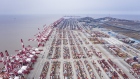 Shipping containers sit stacked next to gantry cranes at the Yangshan Deep Water Port in this aerial photograph taken in Shanghai, China, on Tuesday, Feb. 4, 2020. Chinese officials are hoping the U.S. will agree to some flexibility on pledges in their phase-one trade deal, people familiar with the situation said, as Beijing tries to contain a health crisis that threatens to slow domestic growth with repercussions around the world.