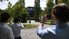 Pedestrians stop to take smartphone photographs of the Wirecard AG headquarters in Munich, Germany, on Thursday, June 25, 2020. Wirecard filed for insolvency, following the arrest of its CEO amid a massive accounting scandal that left the German payment-processing firm scrambling to find over $2 billion dollars missing from its balance sheet.
