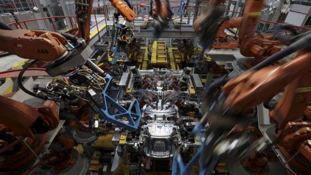 Robotics arms, manufactured by ABB Ltd, operate on the body shell of a Jaguar XE automobile on the production line at Tata Motors Ltd.'s Jaguar assembly plant in Castle Bromwich, U.K., on Thursday, March 16, 2017. Jaguar Land Rover Chief Executive Officer Ralf Speth backed Nissan Motor Co.'s calls for extra funding for car-parts makers in the wake of last years Brexit vote, while cautioning that there must be "fair play" for all U.K. automakers. Photographer: Simon Dawson/Bloomberg