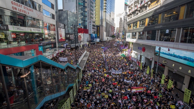 Protesters march during the annual pro-democracy rally in Hong Kong, China, on Monday, July 1, 2019. Tension returned to Hong Kong's streets Monday as protesters attempted to break into the city's legislature and thousands more gathered to march in opposition to the city's China-backed government.