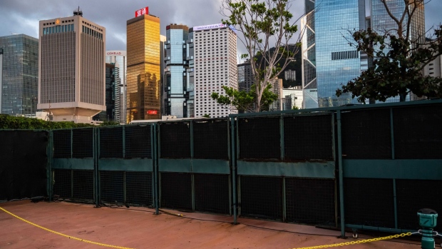 The People's Liberation Army (PLA) Hong Kong Garrison building, left, stands alongside other buildings in the business district in Hong Kong, China, on Monday, June 22, 2020. The U.S. Senate approved a bipartisan measure on June 25 that would penalize banks doing business with Chinese officials involved in the national security law the country is seeking to impose on Hong Kong. Photographer: Billy H.C. Kwok/Bloomberg